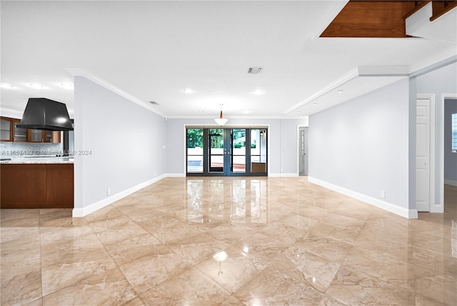 unfurnished living room with ornamental molding