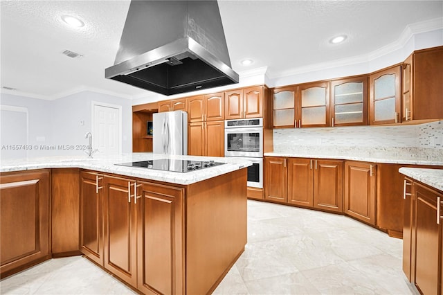 kitchen with stainless steel double oven, white refrigerator, light stone countertops, island exhaust hood, and black electric stovetop