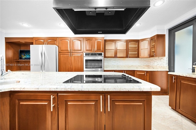 kitchen featuring stainless steel oven, black electric stovetop, freestanding refrigerator, ornamental molding, and ventilation hood