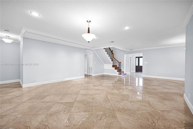 unfurnished living room with baseboards, a textured ceiling, stairs, and ornamental molding