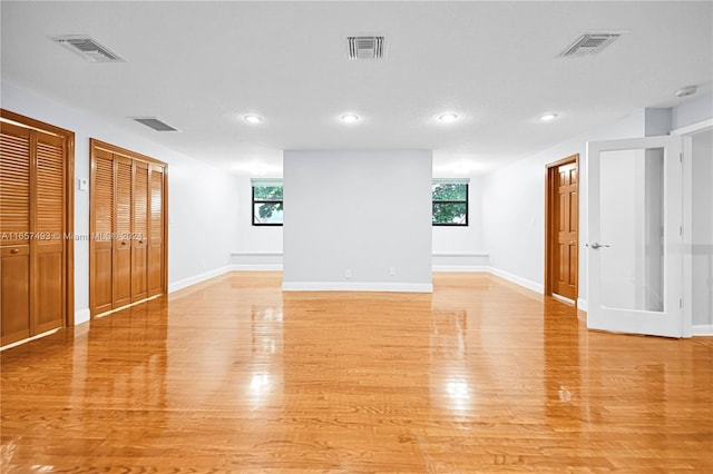 unfurnished room featuring recessed lighting, visible vents, and light wood finished floors