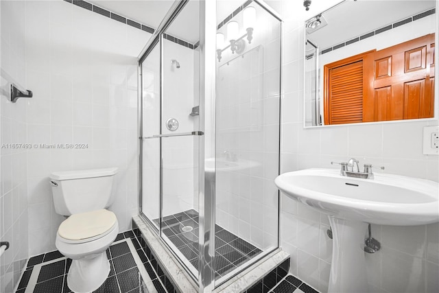 bathroom with toilet, an enclosed shower, tile patterned flooring, backsplash, and tile walls