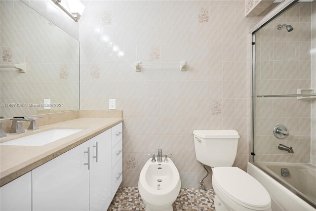 full bathroom with a bidet, vanity, combined bath / shower with glass door, tile walls, and toilet