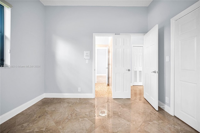 unfurnished bedroom featuring baseboards