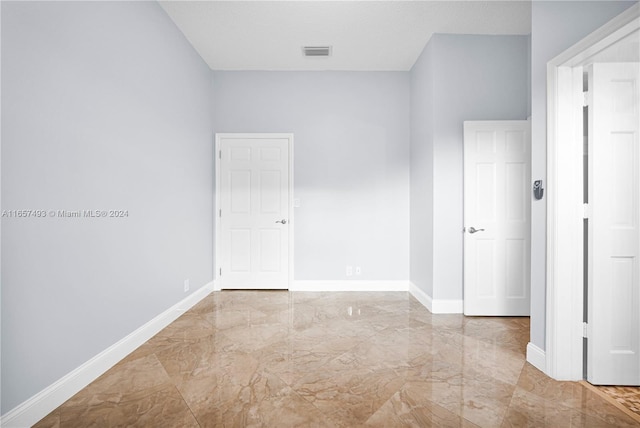 unfurnished room featuring a textured ceiling