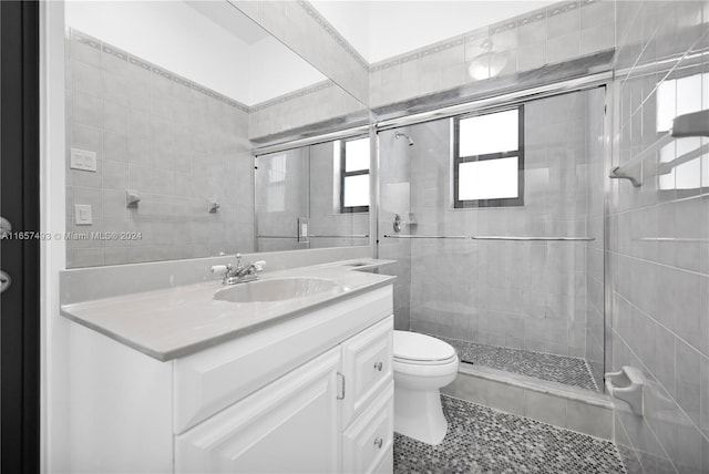 full bath featuring a shower stall, toilet, vanity, and tile patterned flooring