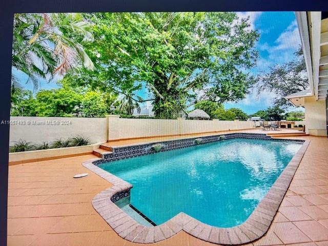 view of pool featuring a fenced in pool and a fenced backyard