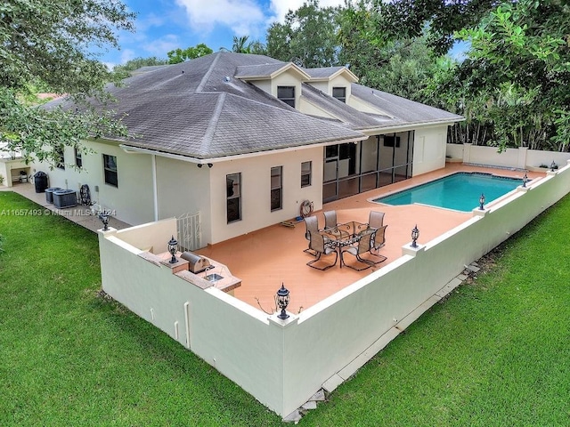 rear view of property with a lawn, a patio area, and central AC unit