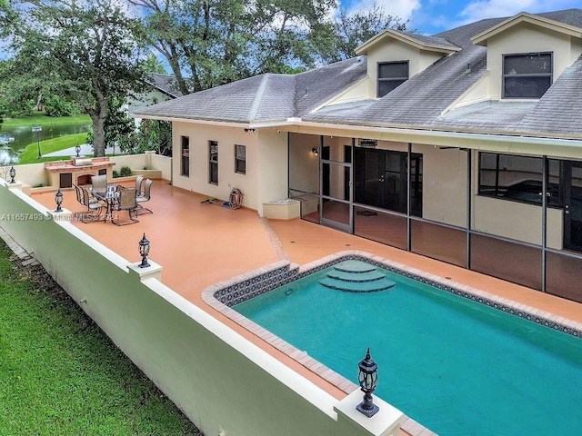 rear view of house with a patio area, a shingled roof, fence, a fenced in pool, and stucco siding