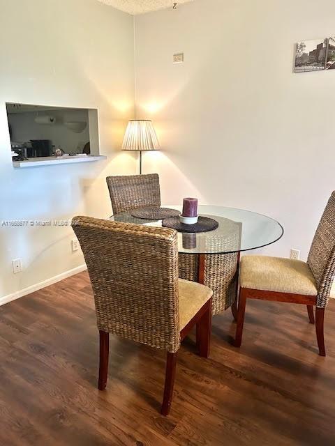 dining area featuring dark hardwood / wood-style flooring