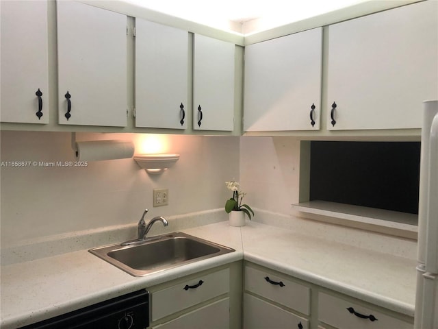 kitchen with white cabinetry, dishwasher, fridge, and sink