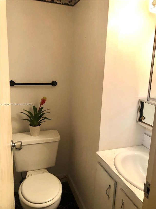 bathroom featuring vanity and toilet