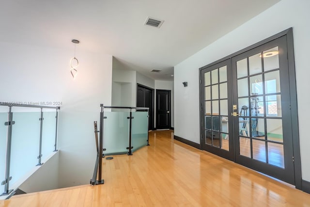 empty room featuring wood-type flooring and french doors