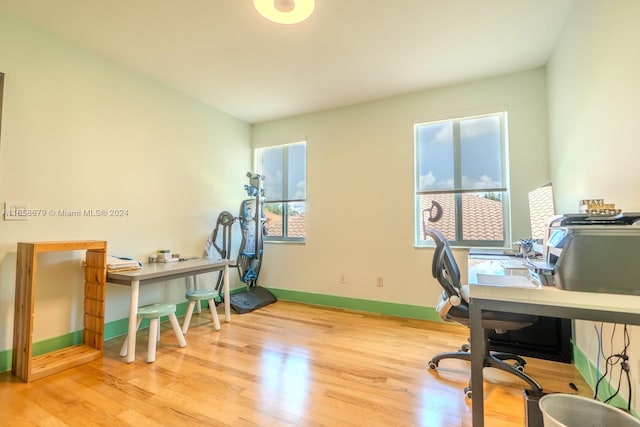 office with light wood-type flooring