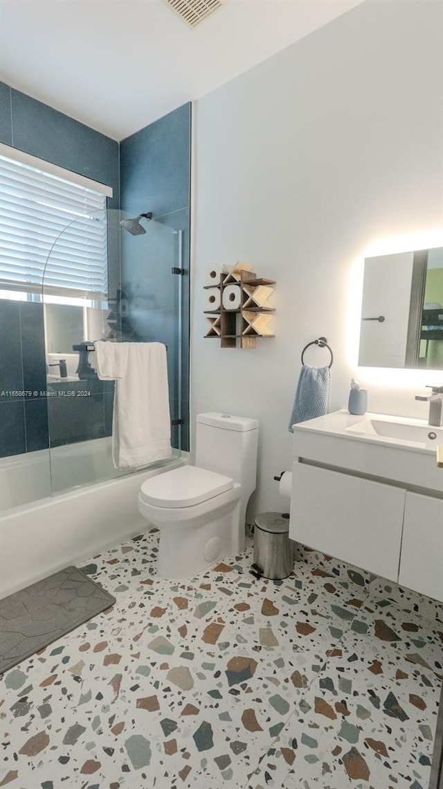 full bathroom with tile patterned flooring, vanity, toilet, and tiled shower / bath combo