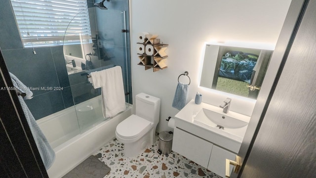 full bathroom featuring shower / bath combination with glass door, vanity, toilet, and tile patterned flooring