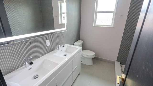 bathroom with tile patterned flooring, vanity, and toilet