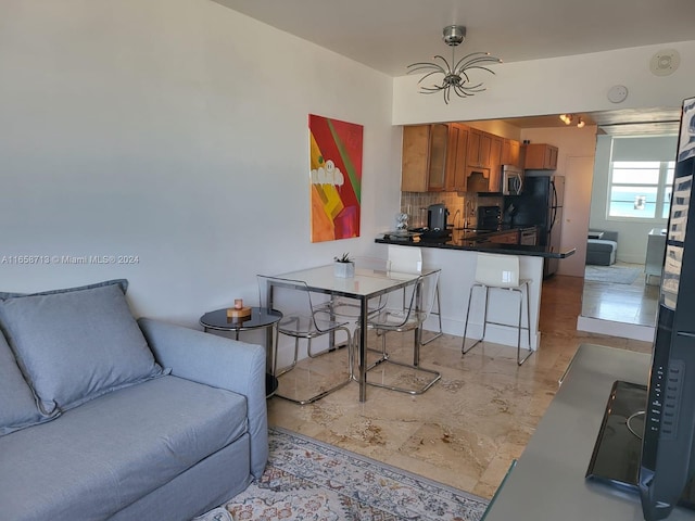 living room featuring a notable chandelier and sink