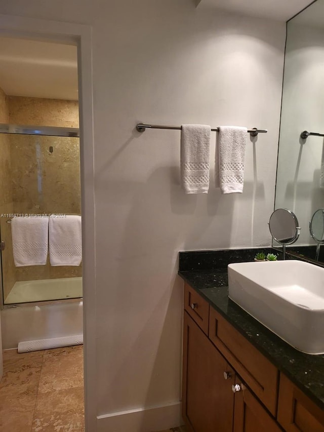 bathroom with enclosed tub / shower combo and vanity