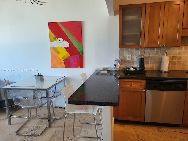 kitchen featuring dishwasher and tasteful backsplash