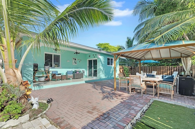 exterior space featuring an outdoor living space, ceiling fan, and a gazebo