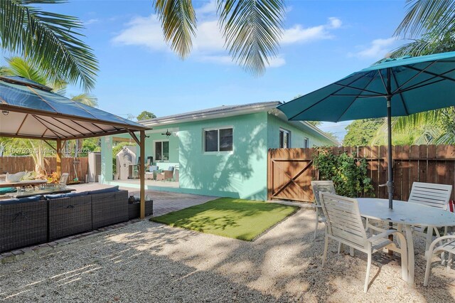 view of patio / terrace with ceiling fan, a gazebo, and an outdoor living space