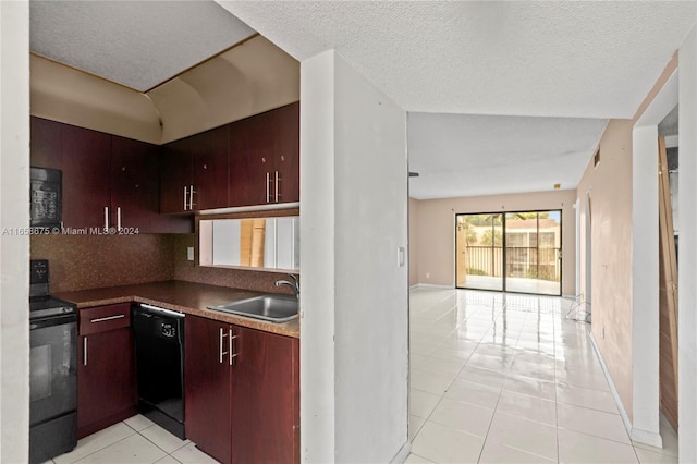 kitchen with a textured ceiling, black appliances, sink, and light tile patterned floors