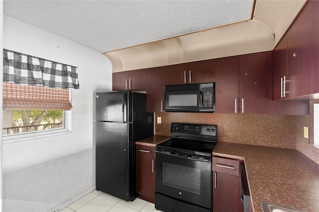 kitchen with black appliances, decorative backsplash, a textured ceiling, and light tile patterned flooring