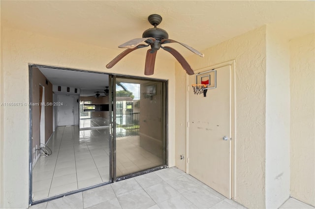 entrance to property featuring ceiling fan