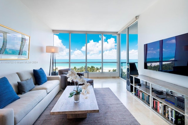 tiled living room featuring floor to ceiling windows