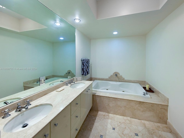 bathroom with tile patterned floors, tiled bath, and vanity