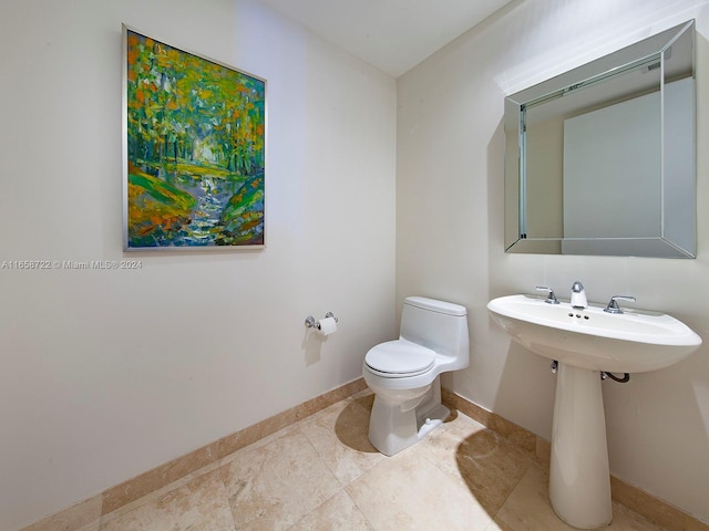 bathroom with toilet and tile patterned floors