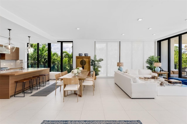 living room with floor to ceiling windows and light tile patterned floors