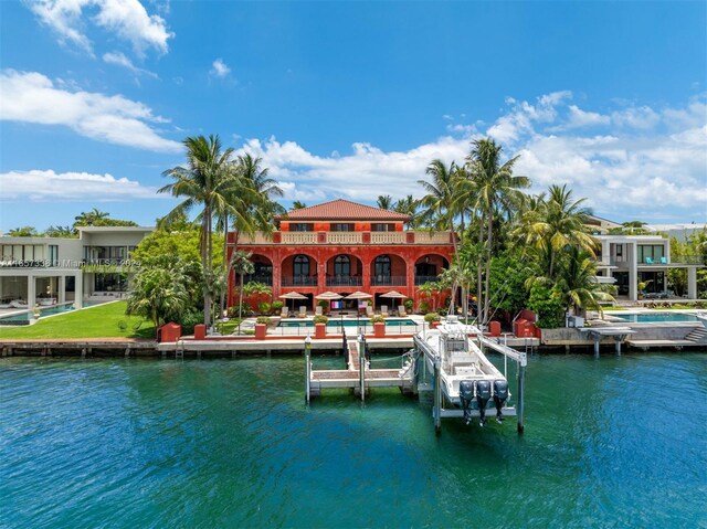 view of dock featuring a balcony, a pool, and a water view