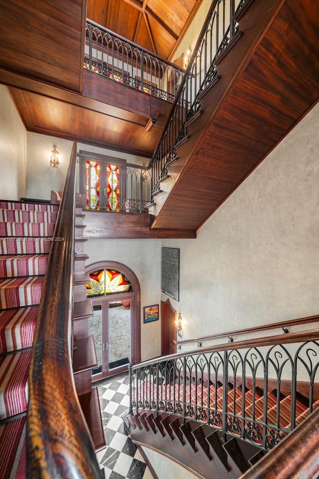 stairway with french doors and wooden ceiling