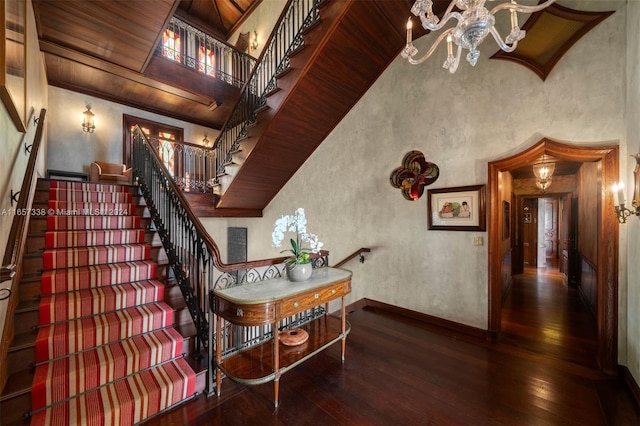 stairs featuring a chandelier and hardwood / wood-style flooring