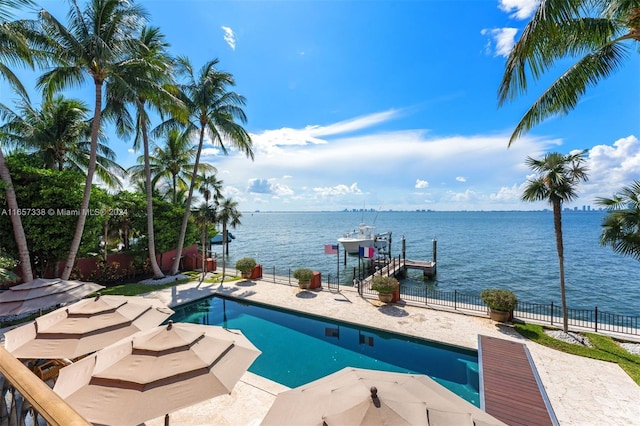 view of pool with a water view and a patio area