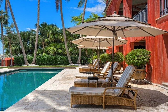 view of swimming pool featuring a patio area