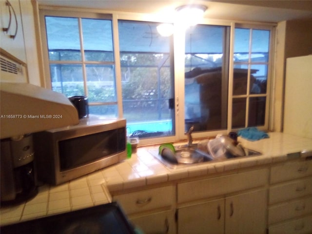 kitchen featuring sink and tile counters