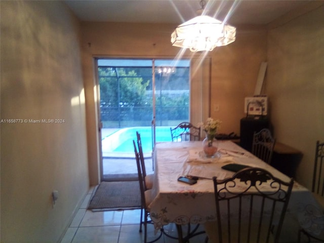 dining room with an inviting chandelier and tile patterned floors