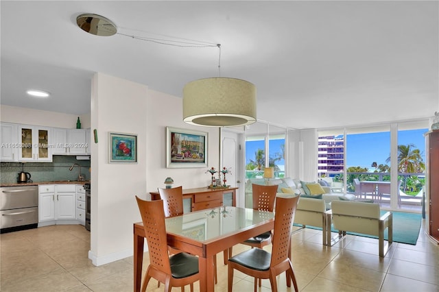 tiled dining room featuring sink