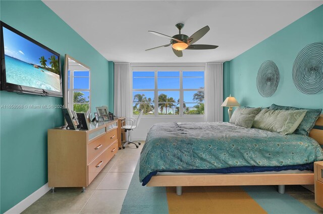 tiled bedroom featuring ceiling fan