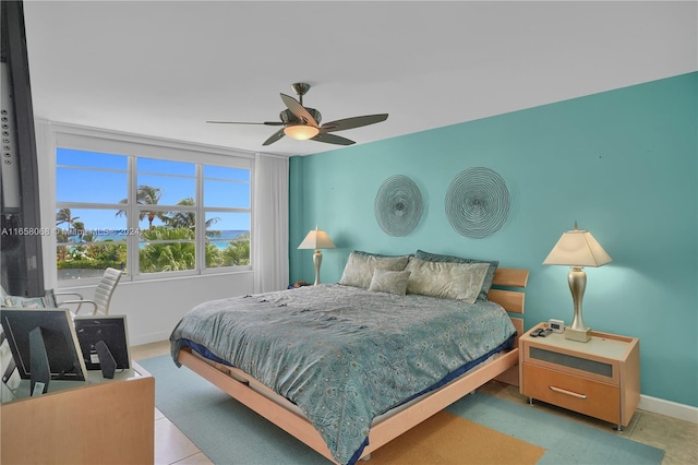 tiled bedroom featuring ceiling fan