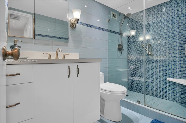 bathroom featuring toilet, an enclosed shower, vanity, decorative backsplash, and tile walls