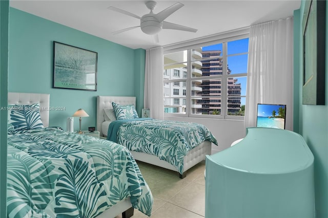 bedroom featuring light tile patterned floors and ceiling fan