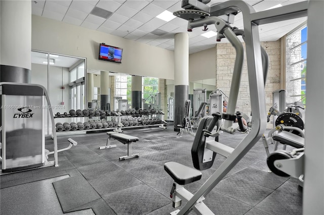 gym with a high ceiling and a drop ceiling