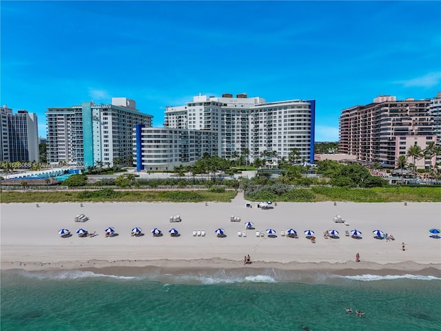 bird's eye view with a water view and a beach view