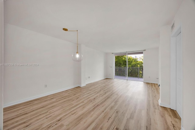 spare room featuring light hardwood / wood-style flooring