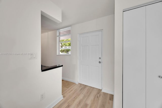 hall with light hardwood / wood-style floors