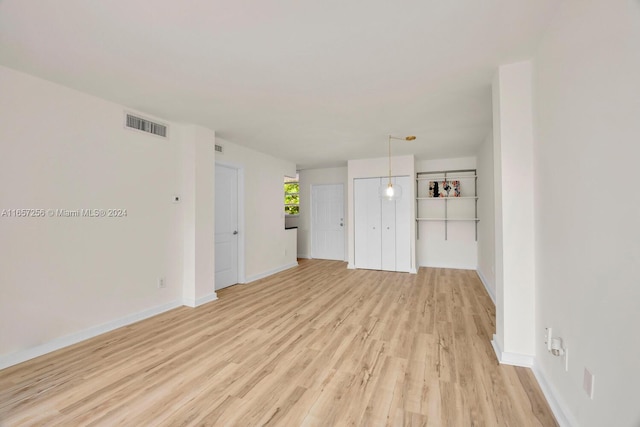 unfurnished living room with light hardwood / wood-style flooring